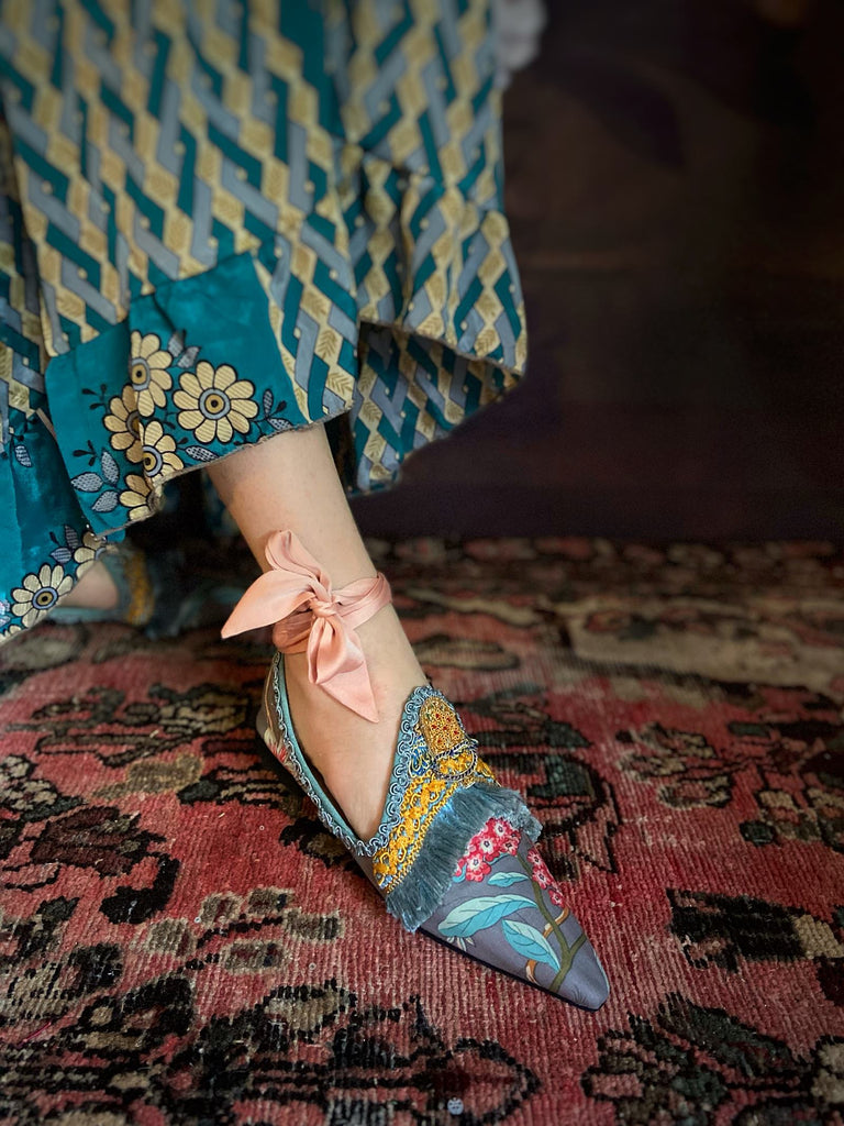 Mitsou Pavilion Parade handmade shoes created from antique textiles,  available from Joanne Fleming Design. Antique French cintz and 19th century passementerie create bohemian flat shoes in shades of pink and teal