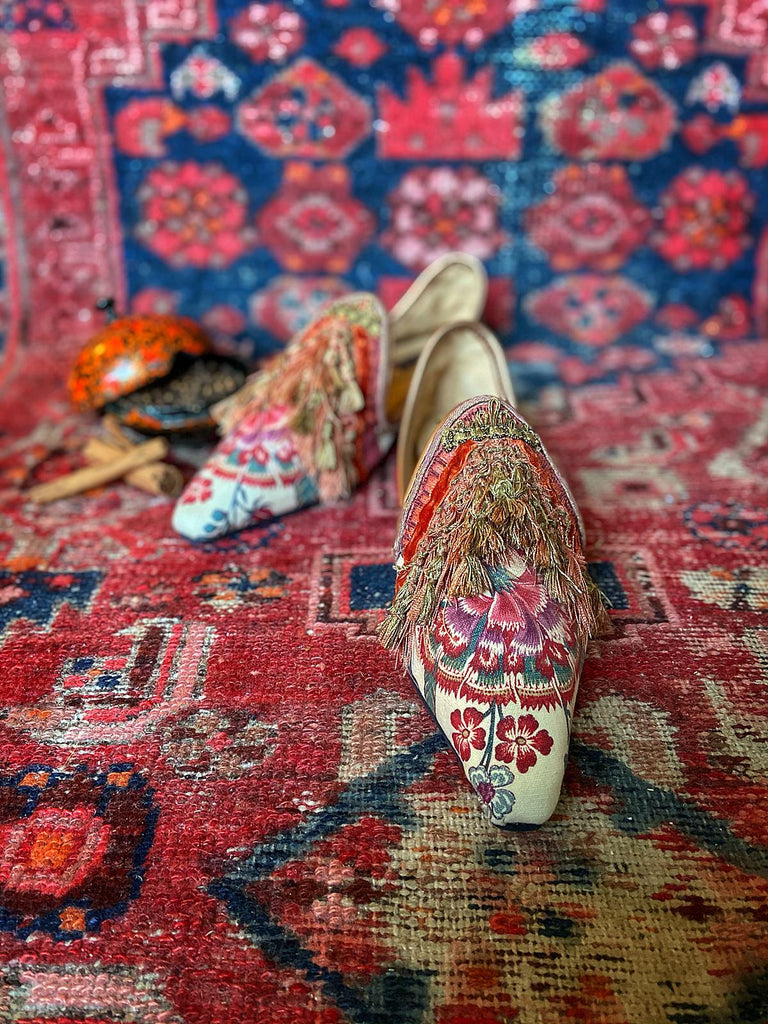 Pavilion Parade handmade shoes created from antique textiles, from available Joanne Fleming Design. 18th century Florentine silk tassels and block printed Indienne cotton create bohemian flat shoes in shades of coral, cream and gold.