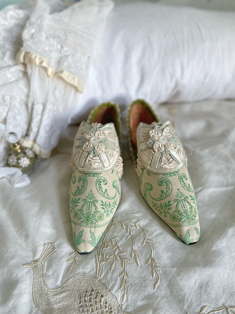 Pea green and creamy ivory brocade pointed toe shoes created from antique textiles. Embellished with original Georgian silk shoe rosettes with mother of pearl detail. Bohemian style from Pavilion Parade.