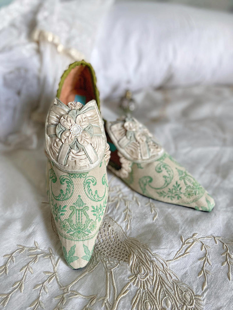 Pea green and creamy ivory brocade pointed toe shoes created from antique textiles. Embellished with original Georgian silk shoe rosettes with mother of pearl detail. Bohemian style from Pavilion Parade.