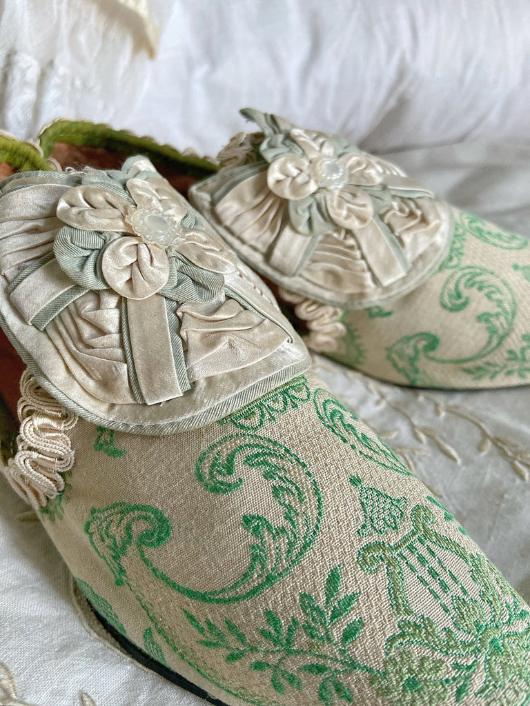 Pea green and creamy ivory brocade pointed toe shoes created from antique textiles. Embellished with original Georgian silk shoe rosettes with mother of pearl detail. Bohemian style from Pavilion Parade.