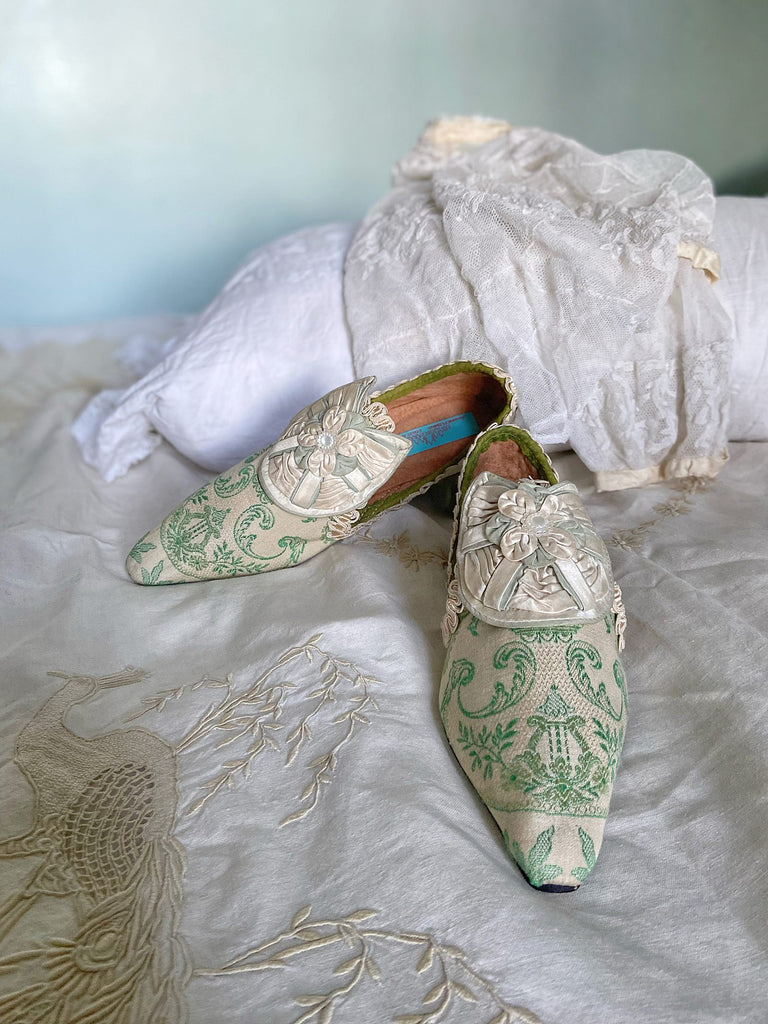 Pea green and creamy ivory brocade pointed toe shoes created from antique textiles. Embellished with original Georgian silk shoe rosettes with mother of pearl detail. Bohemian style from Pavilion Parade.