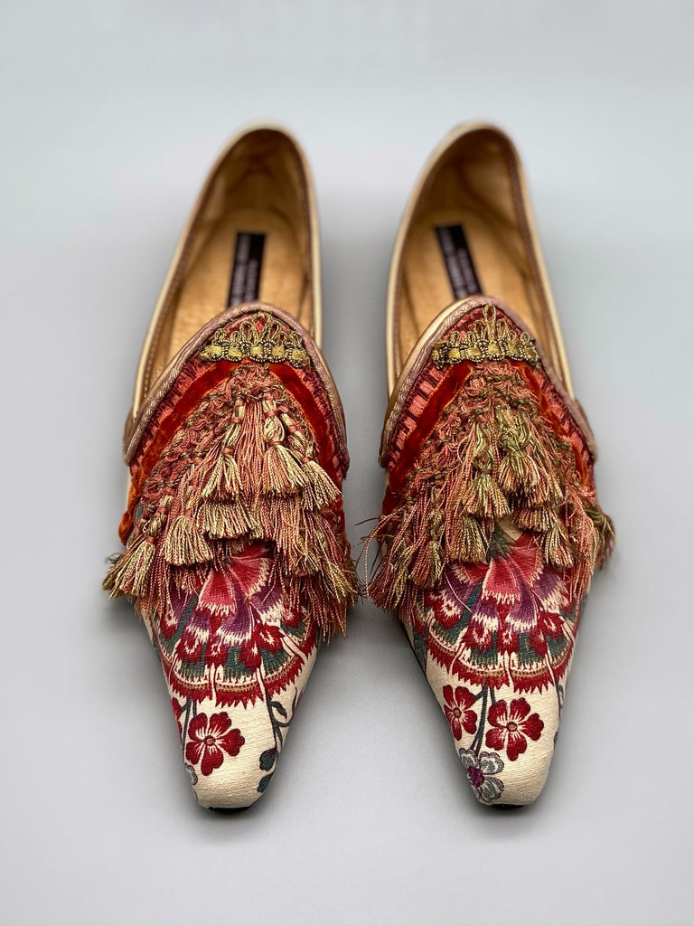 Pavilion Parade handmade shoes created from antique textiles, from available Joanne Fleming Design. 18th century Florentine silk tassels and block printed Indienne cotton create bohemian flat shoes in shades of coral, cream and gold.