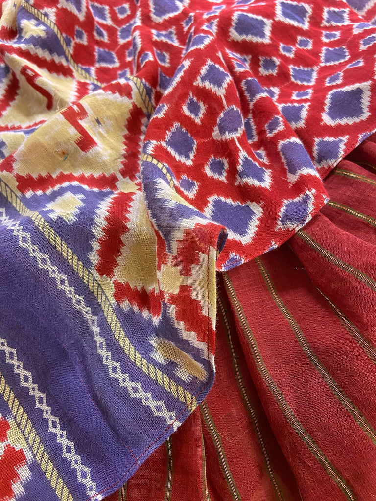 Ruby red and Persian blue printed ikat fine cotton muslin dress with full balloon sleeves, pockets and tiered hem. Bohemian style from the Pavilion Parade studio.
