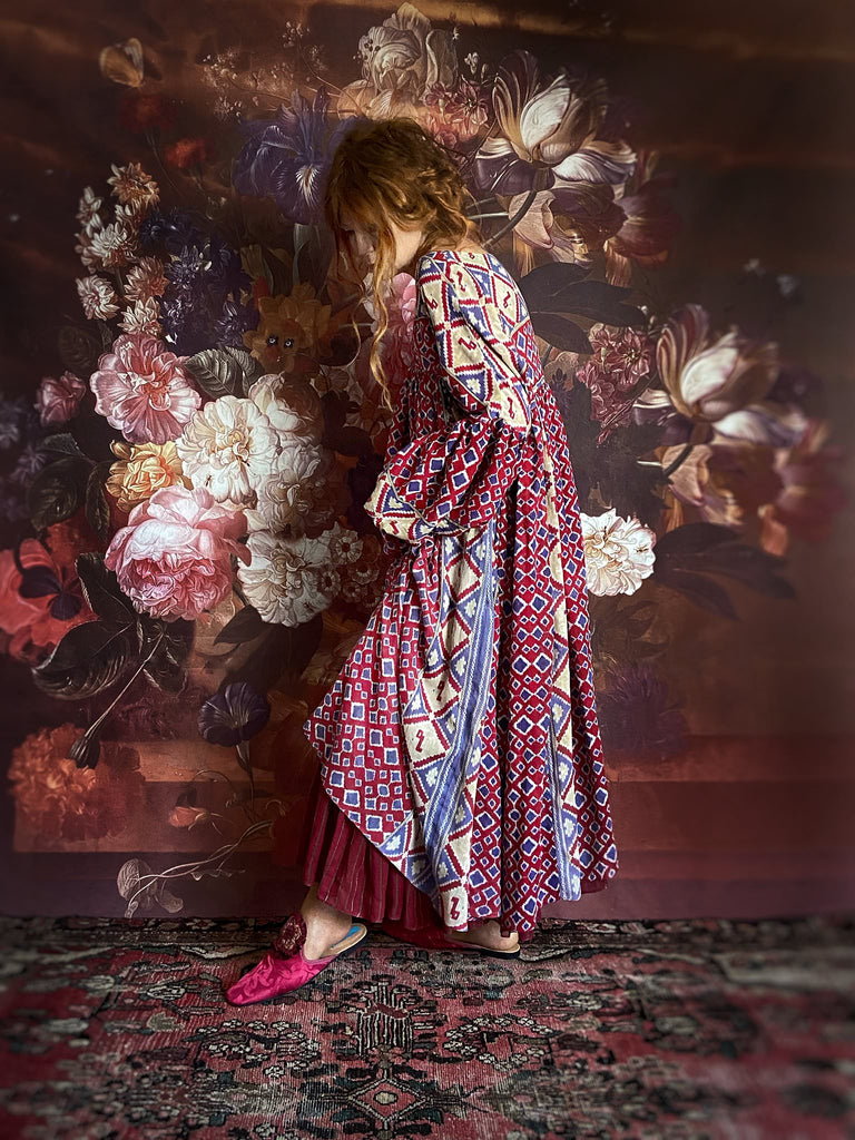 Ruby red and Persian blue printed ikat fine cotton muslin dress with full balloon sleeves, pockets and tiered hem. Bohemian style from the Pavilion Parade studio.