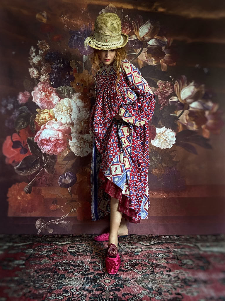 Ruby red and Persian blue printed ikat fine cotton muslin dress with full balloon sleeves, pockets and tiered hem. Bohemian style from the Pavilion Parade studio.