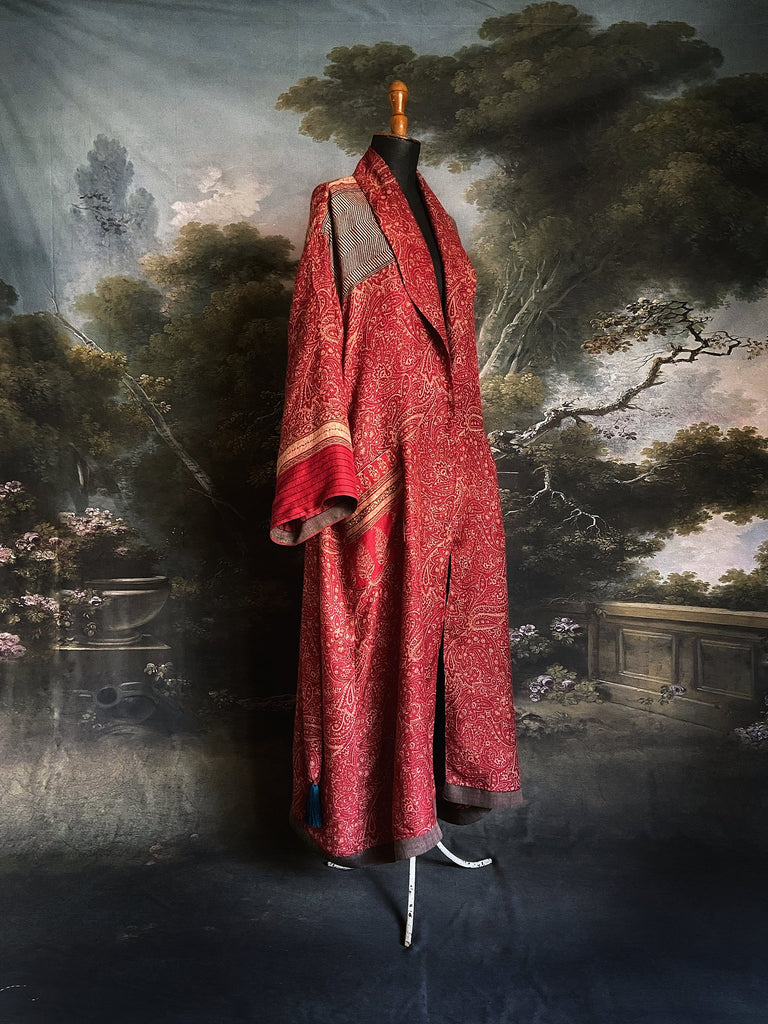 Crimson red fine wool dressing robe or duster coat with tassel sash and vivid Prussian blue block printed silk lining. Sustainably created from vintage and antique textiles by the Pavilion Parade studio.