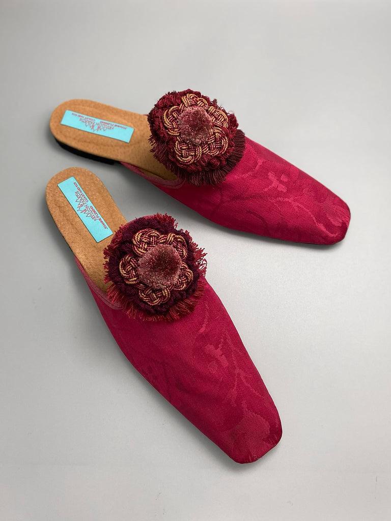 Raspberry red 19th century silk damask square toed backless slipper shoes with antique French passementerie silk chenille and cord medallion rosettes. Bohemian style created from antique textiles by the Pavilion Parade studio.