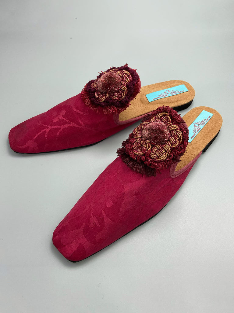 Raspberry red 19th century silk damask square toed backless slipper shoes with antique French passementerie silk chenille and cord medallion rosettes. Bohemian style created from antique textiles by the Pavilion Parade studio.