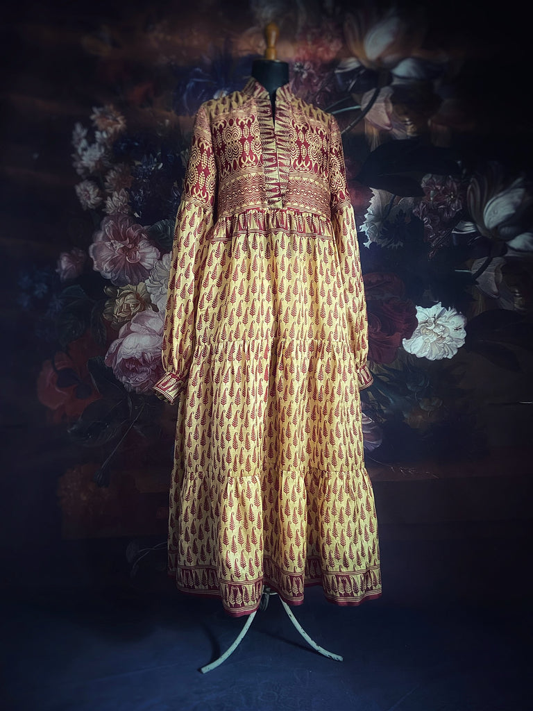 Saffron yellow silk maxi dress with burgundy red feather boteh motif print. Relaxed fit with high neck and long full sleeves. Sustainable one-off Brighton Bohemian piece created from antique and vintage textiles for Pavilion Parade