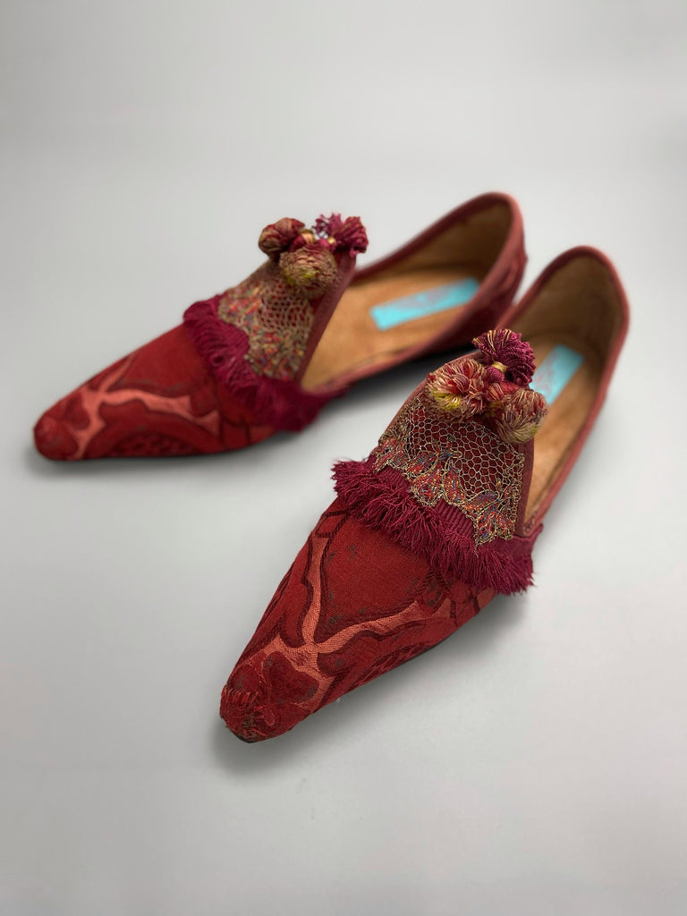 Rust red bohemian shoes created from a fragment of antique Italian silk brocade and assorted tassel and passementerie embellishments by Pavilion Parade
