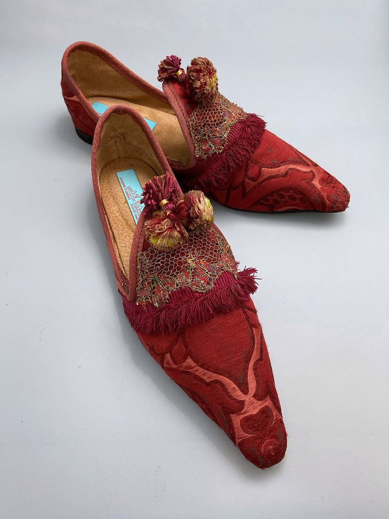 Rust red bohemian shoes created from a fragment of antique Italian silk brocade and assorted tassel and passementerie embellishments by Pavilion Parade