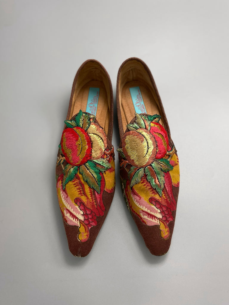 Vibrant colourful bohemian shoes created from an antique French  block printed Indienne cotton, with a design of fantastical flowers and foliage  and embroidered fruits. Sustainably made from antique textiles by Pavilion Parade