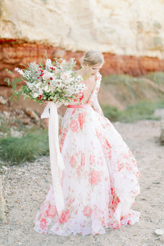Ivory and coral red floral silk organza ball gown  wedding dress with long puffed sleeves and deep illusion plunge neckline. A Flight of Fancy from Pavilion Parade