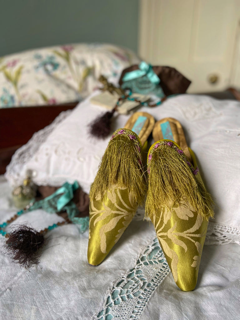 La Fée Verte silk damask bohemian shoes created from antique textiles by Pavilion Parade. Embellished with circa 1700 Florentine silk fringe and 1920s lilac rococo ribbon flower trim. 