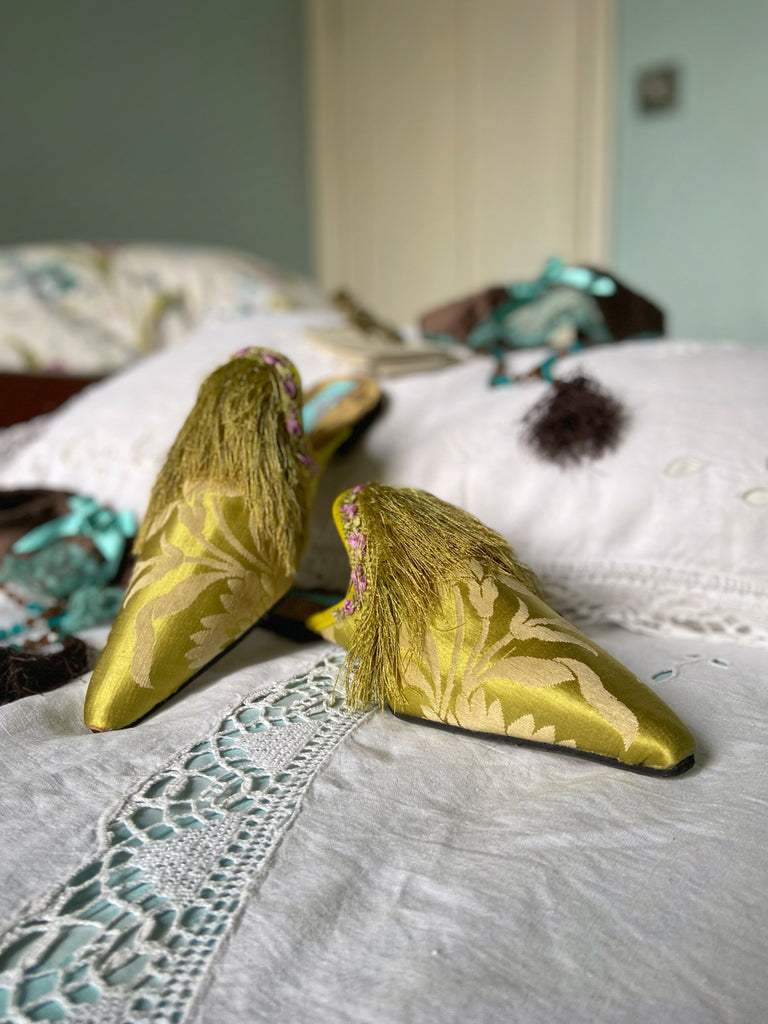 La Fée Verte silk damask bohemian shoes created from antique textiles by Pavilion Parade. Embellished with circa 1700 Florentine silk fringe and 1920s lilac rococo ribbon flower trim. 