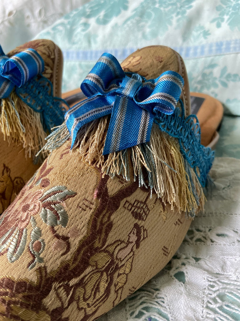 Pavilion Parade handmade shoes created from antique textiles,  available from Joanne Fleming Design. Antique French silk jacquard and 19th century passementerie create bohemian flat shoes in shades of caramel with blue striped silk ribbon bows.