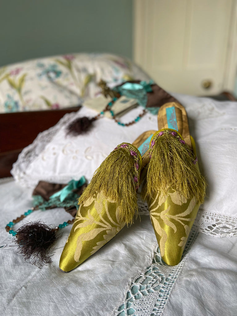 La Fée Verte silk damask bohemian shoes created from antique textiles by Pavilion Parade. Embellished with circa 1700 Florentine silk fringe and 1920s lilac rococo ribbon flower trim. 