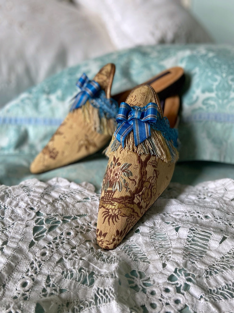 Pavilion Parade handmade shoes created from antique textiles,  available from Joanne Fleming Design. Antique French silk jacquard and 19th century passementerie create bohemian flat shoes in shades of caramel with blue striped silk ribbon bows.