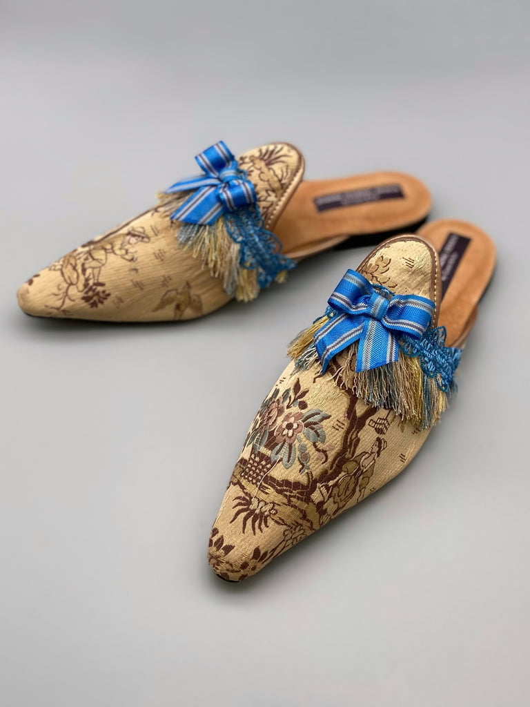 Pavilion Parade handmade shoes created from antique textiles,  available from Joanne Fleming Design. Antique French silk jacquard and 19th century passementerie create bohemian flat shoes in shades of caramel with blue striped silk ribbon bows.