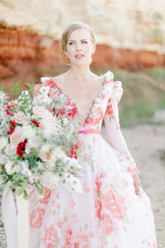 Ivory and coral red floral silk organza ball gown  wedding dress with long puffed sleeves and deep illusion plunge neckline. A Flight of Fancy from Pavilion Parade