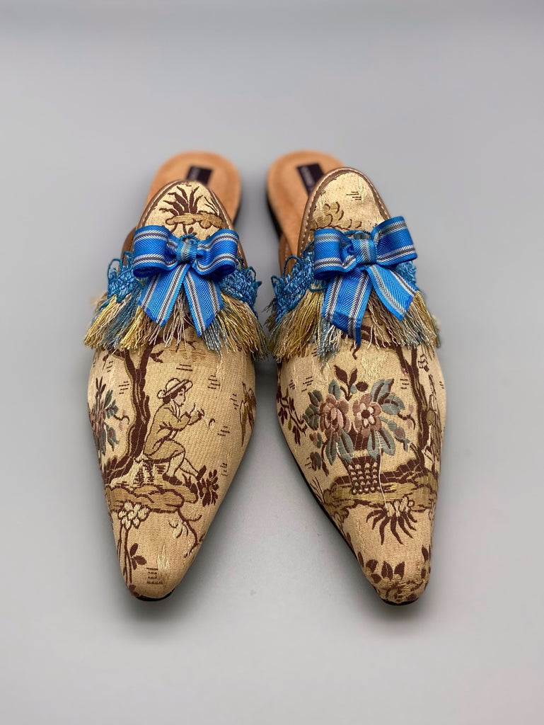 Pavilion Parade handmade shoes created from antique textiles,  available from Joanne Fleming Design. Antique French silk jacquard and 19th century passementerie create bohemian flat shoes in shades of caramel with blue striped silk ribbon bows.