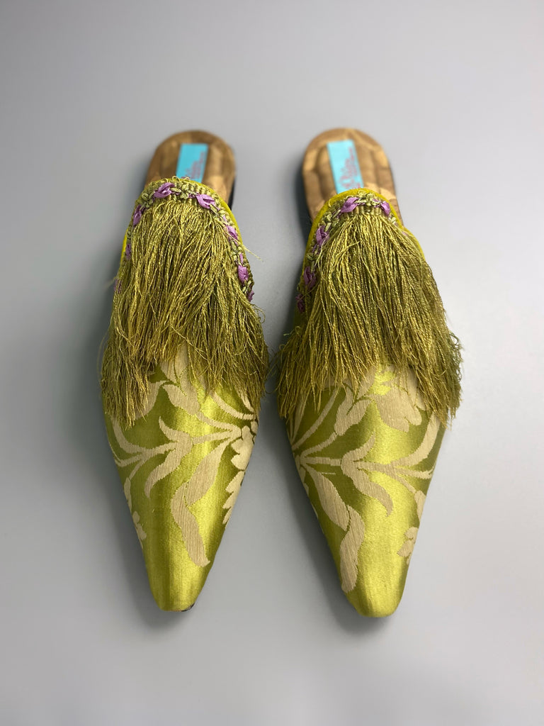 La Fée Verte silk damask bohemian shoes created from antique textiles by Pavilion Parade. Embellished with circa 1700 Florentine silk fringe and 1920s lilac rococo ribbon flower trim. 