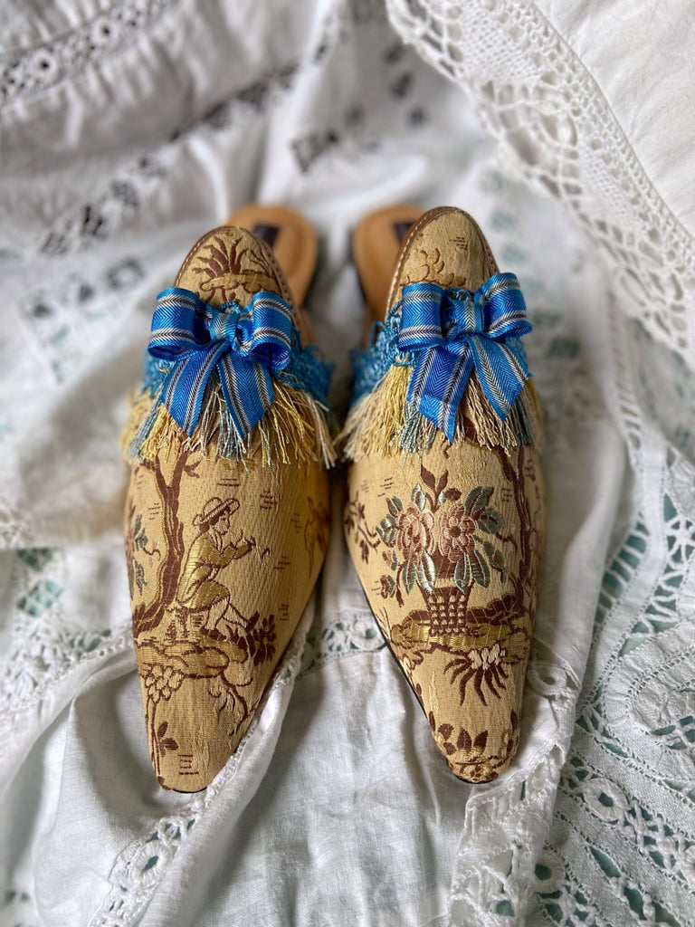 Pavilion Parade handmade shoes created from antique textiles,  available from Joanne Fleming Design. Antique French silk jacquard and 19th century passementerie create bohemian flat shoes in shades of caramel with blue striped silk ribbon bows.