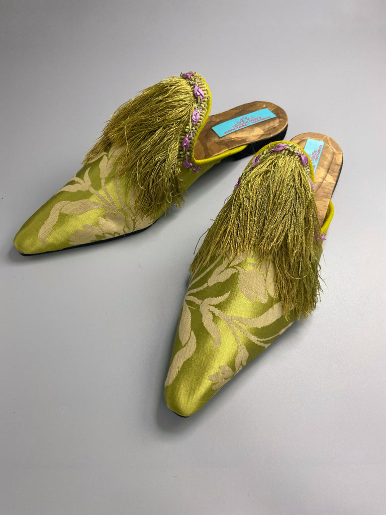 La Fée Verte silk damask bohemian shoes created from antique textiles by Pavilion Parade. Embellished with circa 1700 Florentine silk fringe and 1920s lilac rococo ribbon flower trim. 