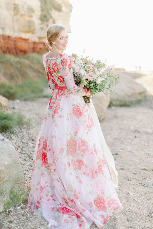 Ivory and coral red floral silk organza ball gown  wedding dress with long puffed sleeves and deep illusion plunge neckline. A Flight of Fancy from Pavilion Parade