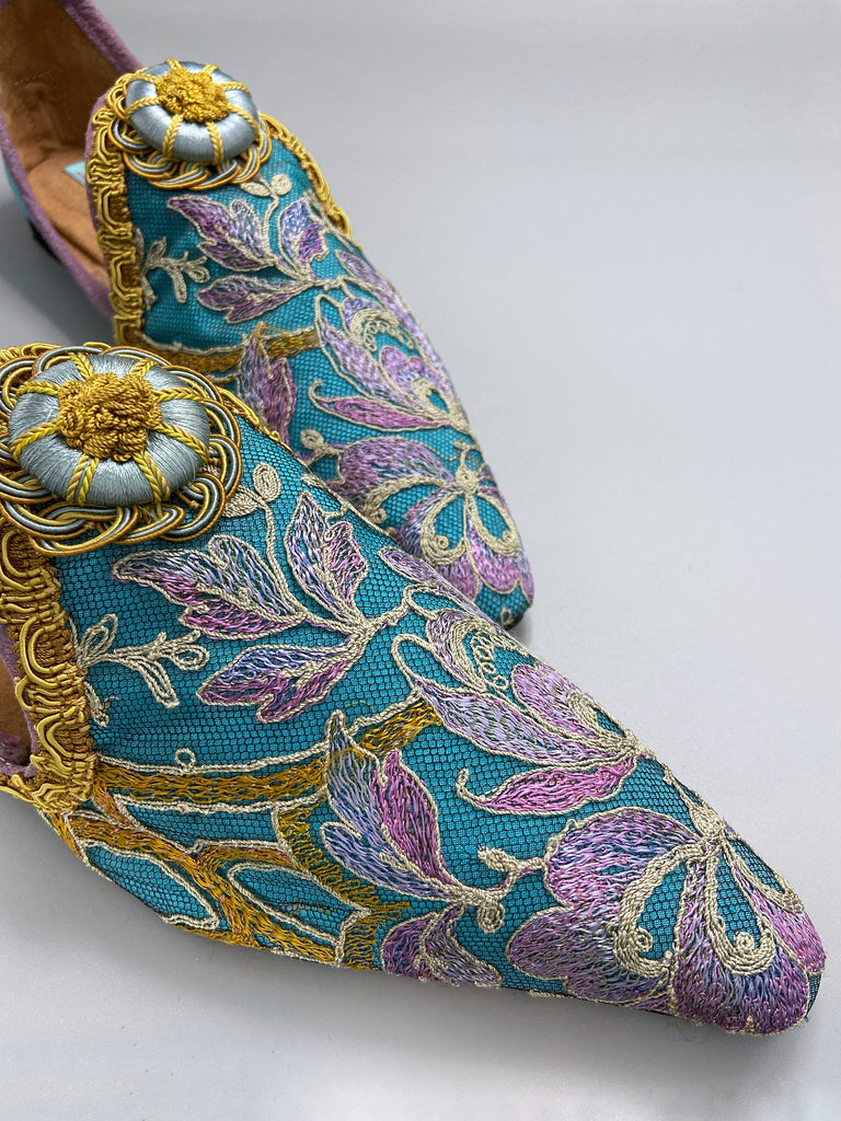 Pointed toe shoes created from antique lilac and gold lace over azure blue silk, with gold braid and vintage Passementerie rosette embellishment. Created by Pavilion Parade.
